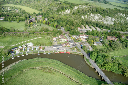 Aerial view towards Amberley with boats on the River Arun ang the road over the bridge. © Geoff