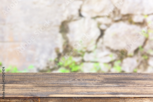 wood table top on blur stone wall background