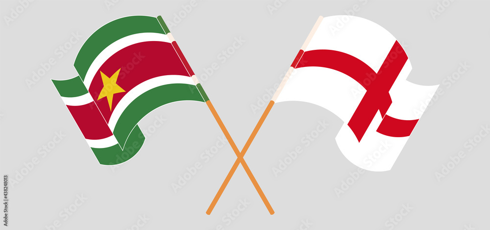 Crossed and waving flags of Suriname and England Crossed and waving flags of Suriname and England