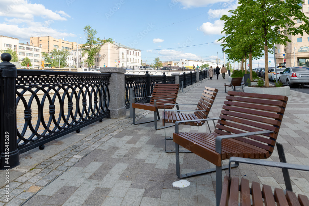 Single benches in the city. Bank of the river.