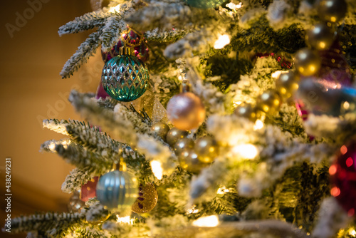 Christmas tree ornaments with gold and green bulbs. Close up © Jessica