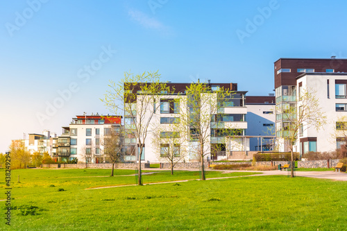 Residential area in city. European complex of modern apartment buildings. Outdoor facilities. Green lawn, young trees, spring. Eco-friendly living in city. Scandinavian architecture. Helsinki, Finland