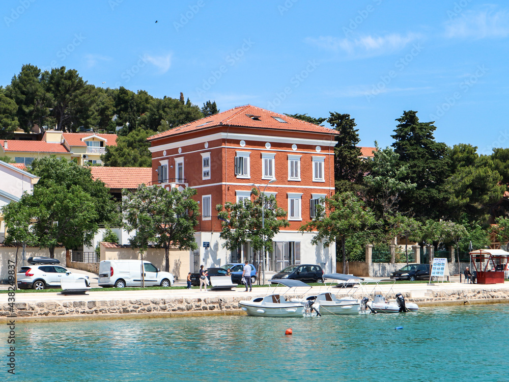 Wonderful old house with colorful facade on the shore of Tisno bay, located on the island of Murter, Croatia
