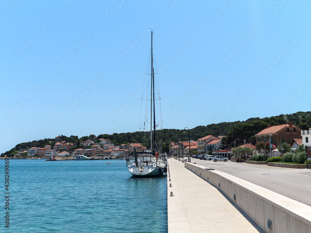 Anchored sailboats at the small town of Tisno on the Murter island, Croatia, at the start of new tourist season