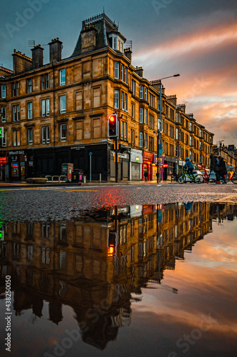Glasgow Scotland June 2021 Sandstone tenement flats reflecting in water at sunset in Glasgow