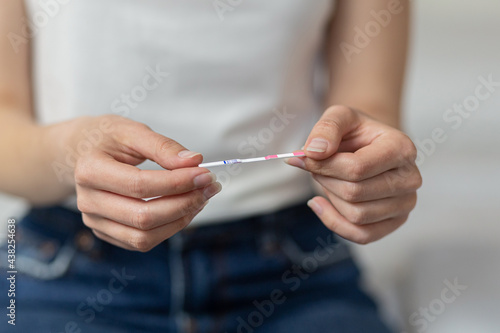 Closeup woman hand holding  pregnancy test. health care concept, selective focus

