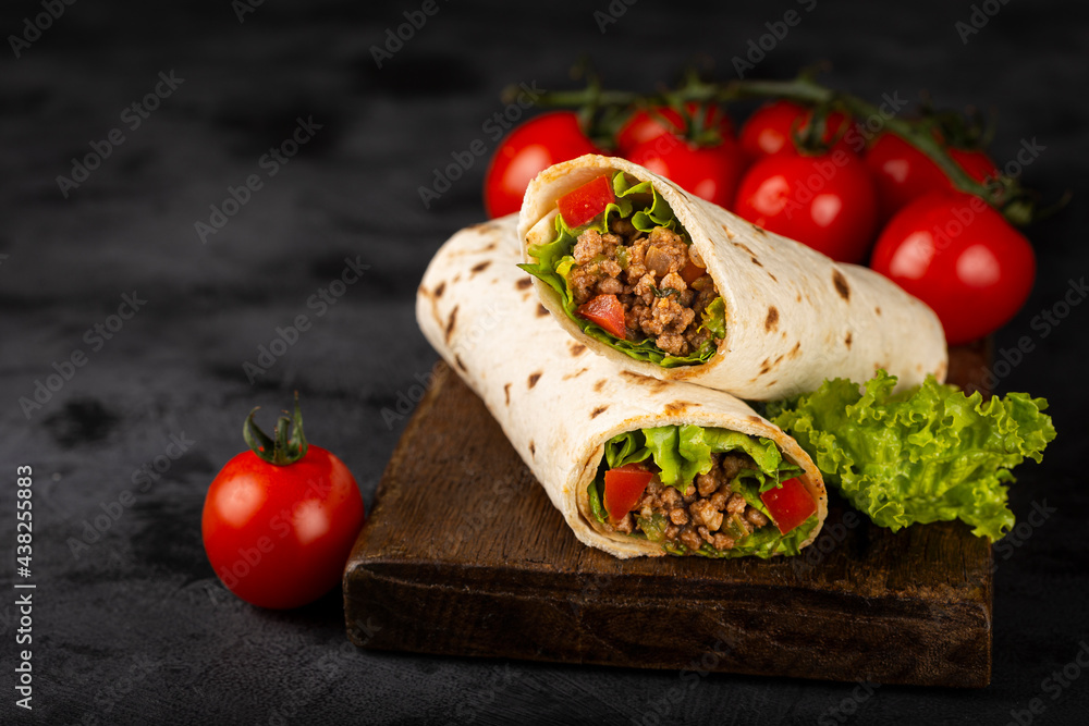 Mexican burritos stuffed with beef and salad. Mexican burritos stuffed with beef and salad.