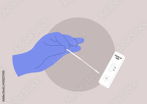 A coronavirus PCR express test kit, a hand holding a cotton swab next to a plastic cassette with strip indicators