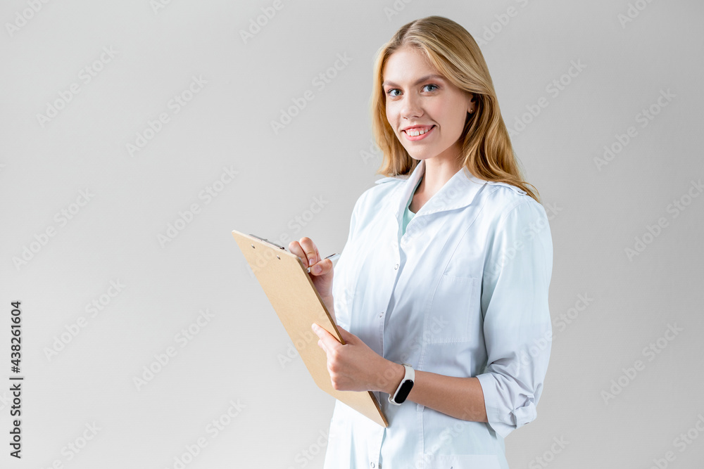 Portrait of young happy female doctor with clipboard in her hands. Medical checkup. records readings, medical session. Portrait of young happy female doctor with clipboard in her hands. Medical checkup. records readings, medical session.