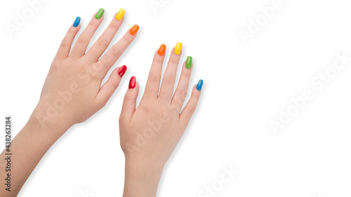 Colorful nails. Rainbow colors manicure. Woman hands after nail salon. Glossy nail polish. Gel or acrylic fake or false nails. Art nail design on fingers. Gay or LGBT style. White isolated background.