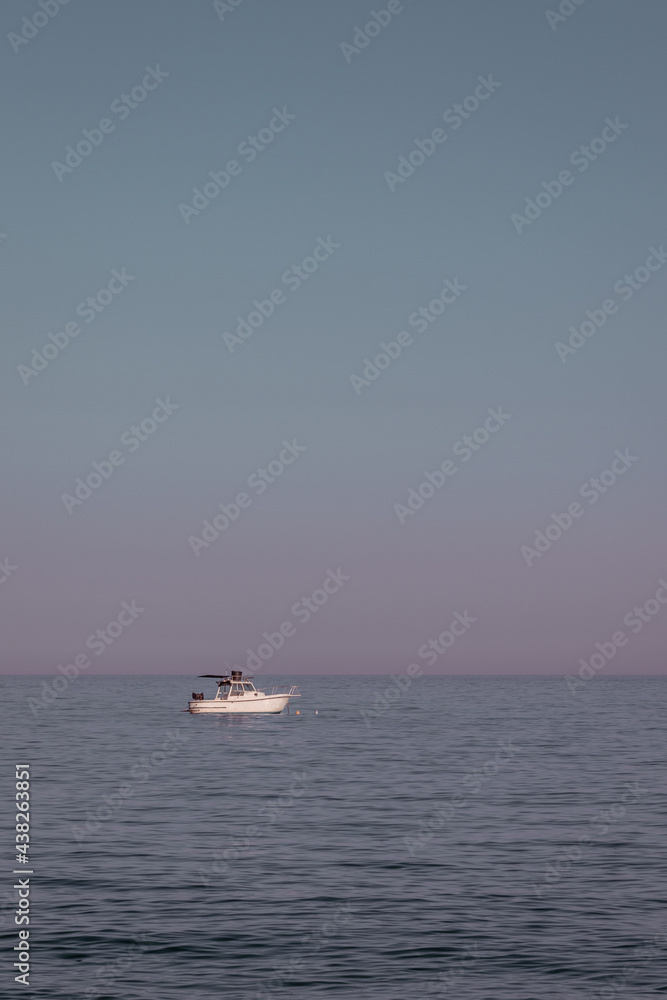 A small boat on a super calm sea 