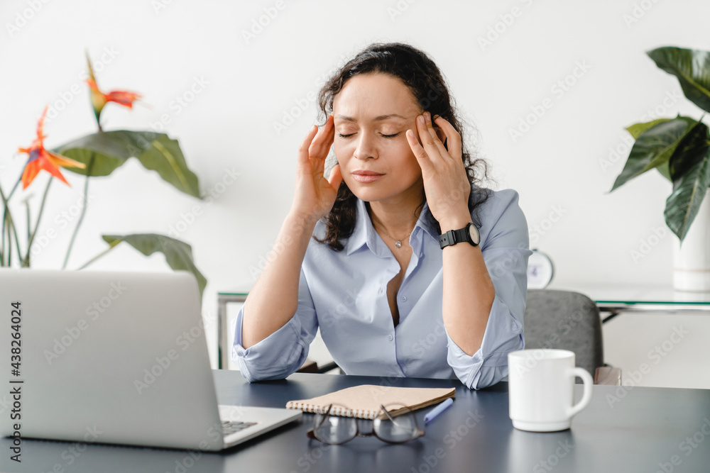 Obraz premium Tired sad exhausted mature businesswoman tutor online teacher feeling migraine after huge load of a computer working on lockdown. Headache and depression, fatigue concept