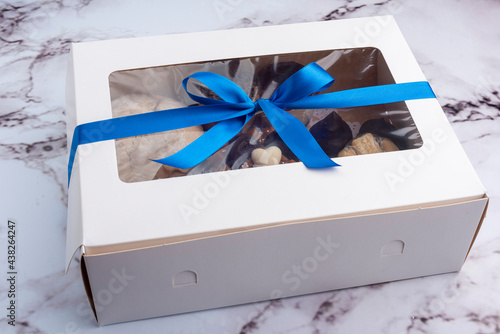 food gift box with blue bow on marble countertop
