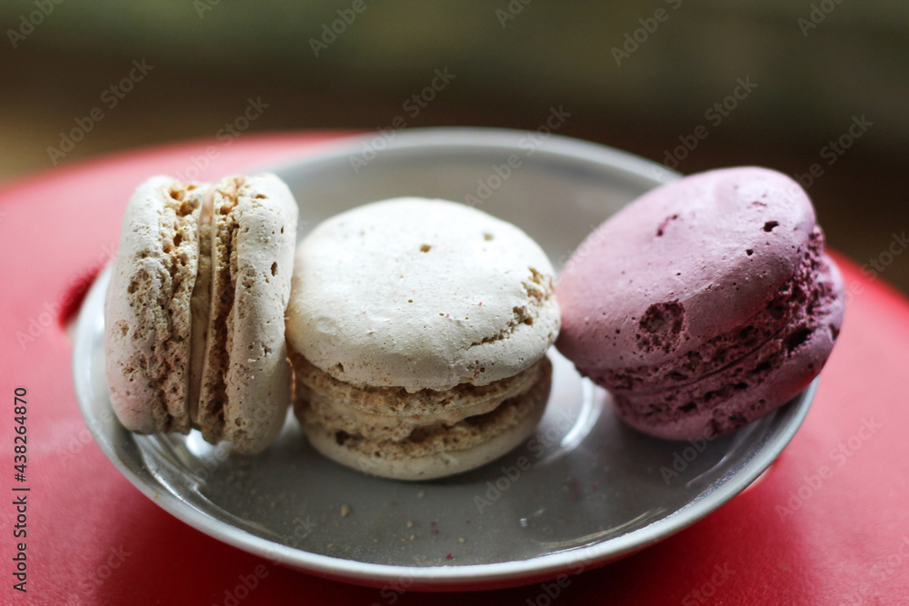 isolated white and pink macaroons on a plate isolated white and pink macaroons on a plate