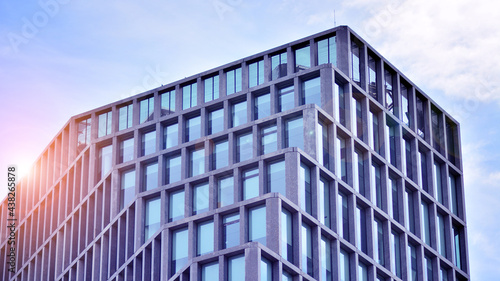 Abstract image of looking up at modern glass and concrete building. Architectural exterior detail of office building. Industrial art and detail. Sunrise.