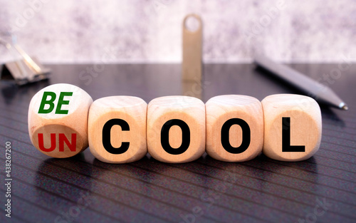 uncool and becool word on wooden block, concept photo