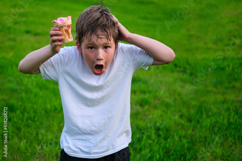 Shocked boy with empty ice cream cup, cheating with food