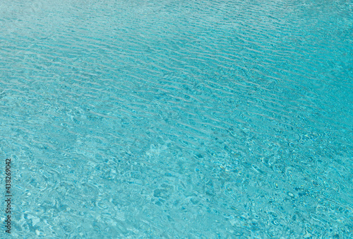Sea water background. Blue sea surface with ripples. Rippled texture of ocean surface