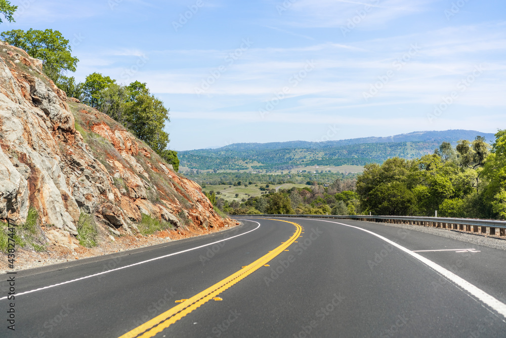 Empty highway going through the Sierra Foothills; Calaveras County, California