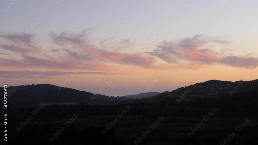 Slow motion shot of cloudy soft pink and purple sunset behind Mediterranean landscape and hills in Chia, Southern Sardinia, Italy Slow motion shot of cloudy soft pink and purple sunset behind Mediterranean landscape and hills in Chia, Southern Sardinia, Italy