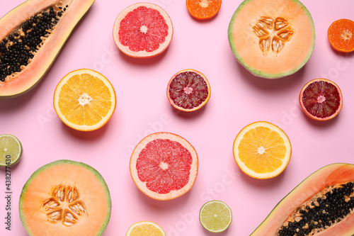 Different exotic fruits on pink background, flat lay