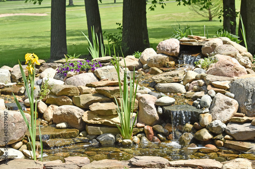 Backyard water feature in the backyard of a home creates a relaxing lifestyle.