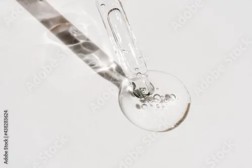 Obraz A drop of cosmetic oil falls from the pipette