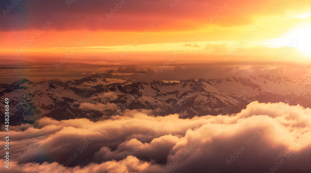 Aerial View from Airplane of Canadian Mountain Landscape in Spring time. Colorful Sunset Sky Art Render North of Vancouver, British Columbia, Canada.