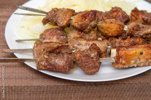 fried kebabs pieces of meat on metal skewers