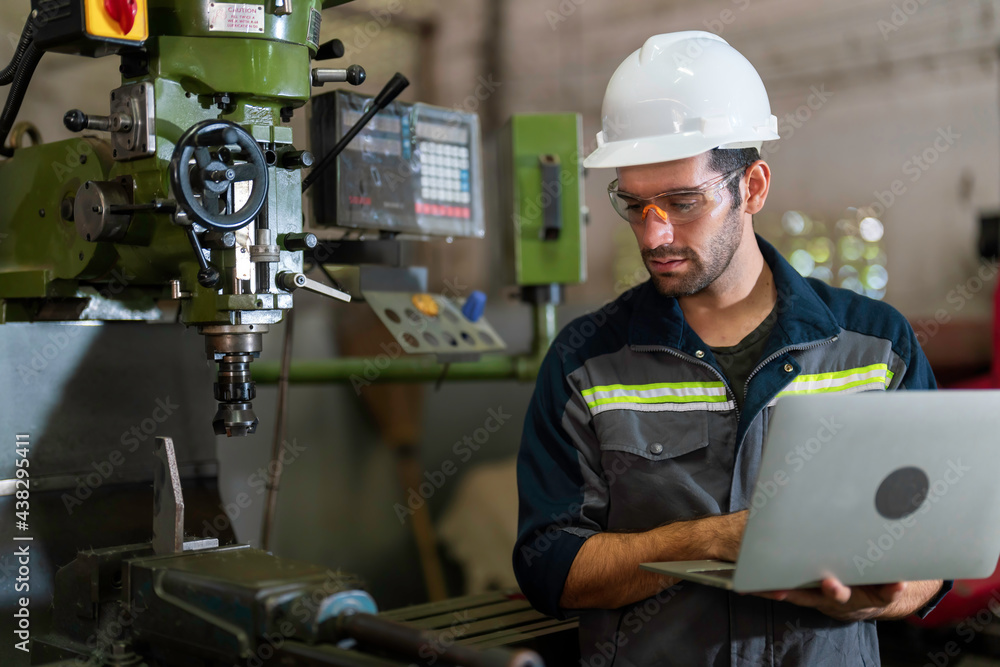 Mechanical engineer holding the laptop computer and working for maintenance or repairing the machine in factory. Mechanical engineer holding the laptop computer and working for maintenance or repairing the machine in factory.
