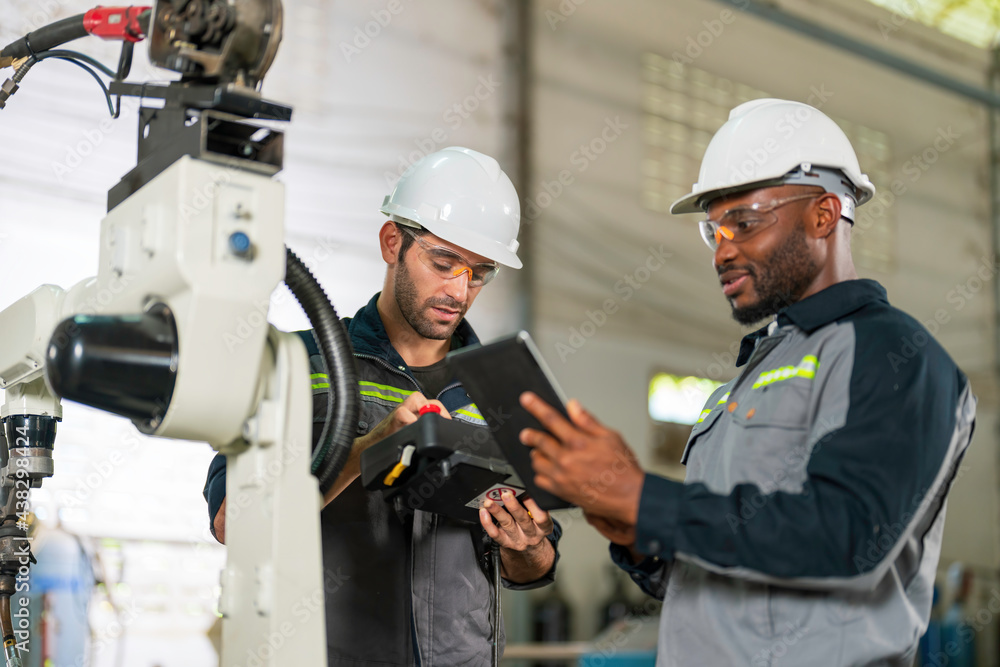 Two Industry engineers stand and discussion work in the factory workshop. Two Industry engineers stand and discussion work in the factory workshop.