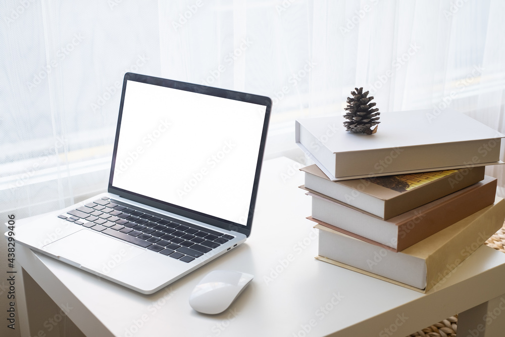 Laptop or computer notebook with blank white screen on white table with mouse. Home interior or office background. Laptop or computer notebook with blank white screen on white table with mouse. Home interior or office background.