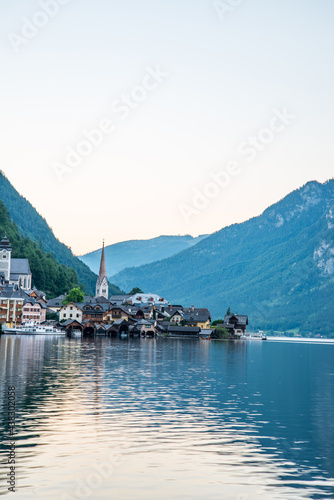 Scenic view of famous Hallstatt lakeside town reflecting in Hallstattersee lake in the Austrian Alps on a sunny day in summer, Salzkammergut region, Austria