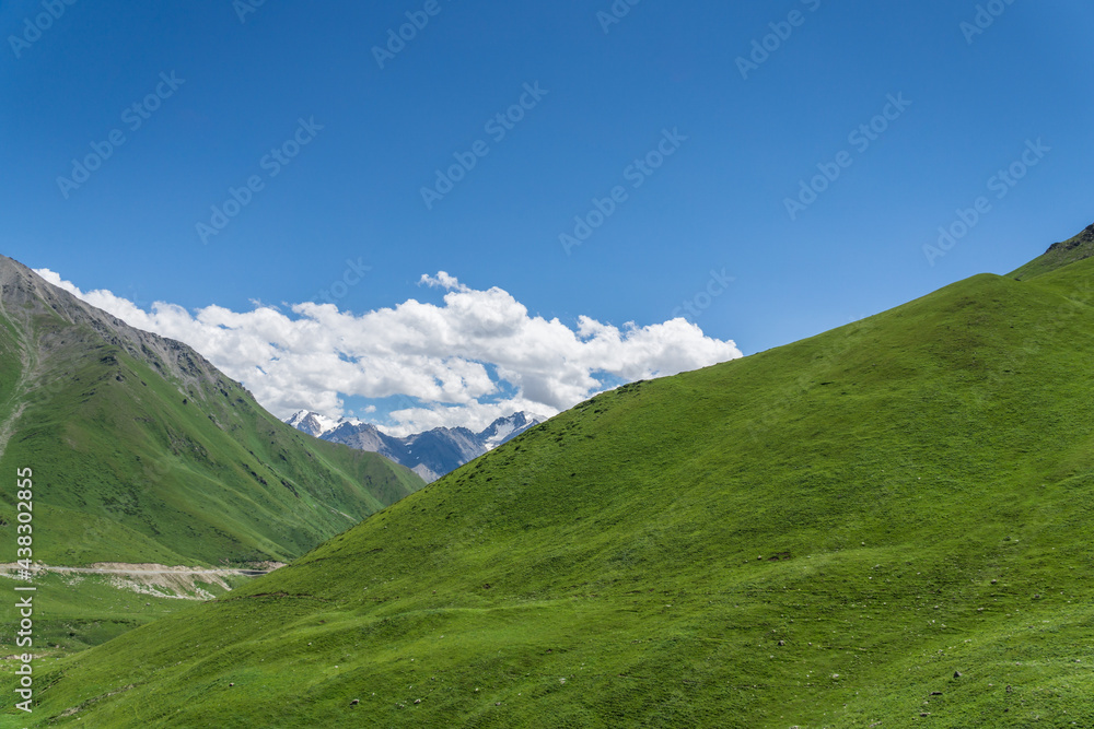 Mountains and grasslands along G217 highway in Xinjiang, China in summer