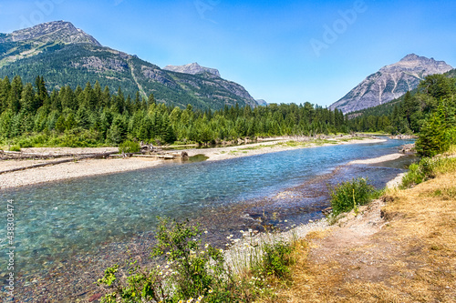 Beautiful river landscape with mountains in sunny summer day. Location place is Flathead river. Glacier National park, Montana photo