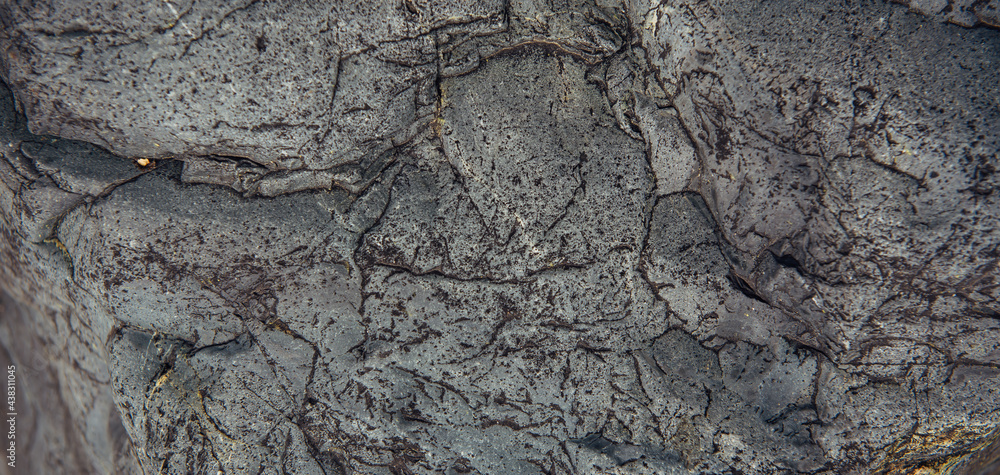 Abstract stone background. Rough surface of gray rock with cracks and natural pattern, close up. Texture for design. Abstract stone background. Rough surface of gray rock with cracks and natural pattern, close up. Texture for design.