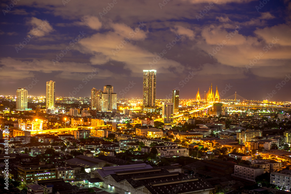 The high angle background of the city view with the secret light of the evening, blurring of night lights, showing the distribution of condominiums, dense homes in the capital community