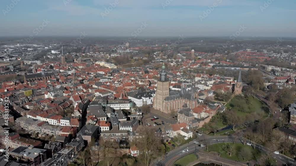 Picturesque aerial approach of medieval Hanseatic city Zutphen in The Netherlands with central Walburgiskerk tower in the foreground against a blue sky Picturesque aerial approach of medieval Hanseatic city Zutphen in The Netherlands with central Walburgiskerk tower in the foreground against a blue sky