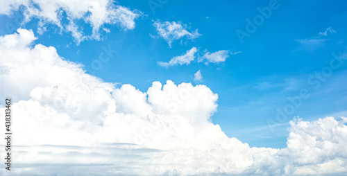 Summer blue sky with white cloud as background on a sunny day. Abstract cloud on blue sky background. Panorama view of the sky for background and wallpaper. © Nos