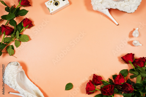 Wedding and bridal theme framed border flat lay with high heel shoes and bouquet on a background. Negative copy space. photo