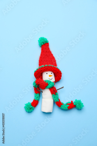Funny snowman made of marshmallows on color background © Pixel-Shot