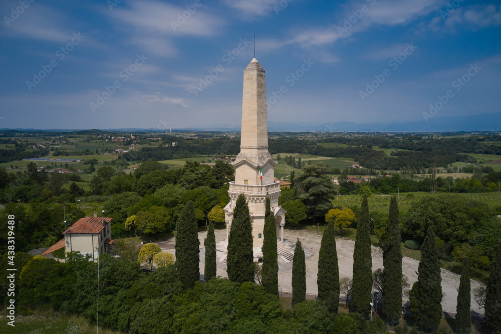 Italian flag at the Ossuary of Custoza museums. Aerial view of the Ossuary of Custoza Italian History Museum on the hill. Ossuary of Custoza, Verona, Italy. Italian flag at the Ossuary of Custoza museums. Aerial view of the Ossuary of Custoza Italian History Museum on the hill. Ossuary of Custoza, Verona, Italy.