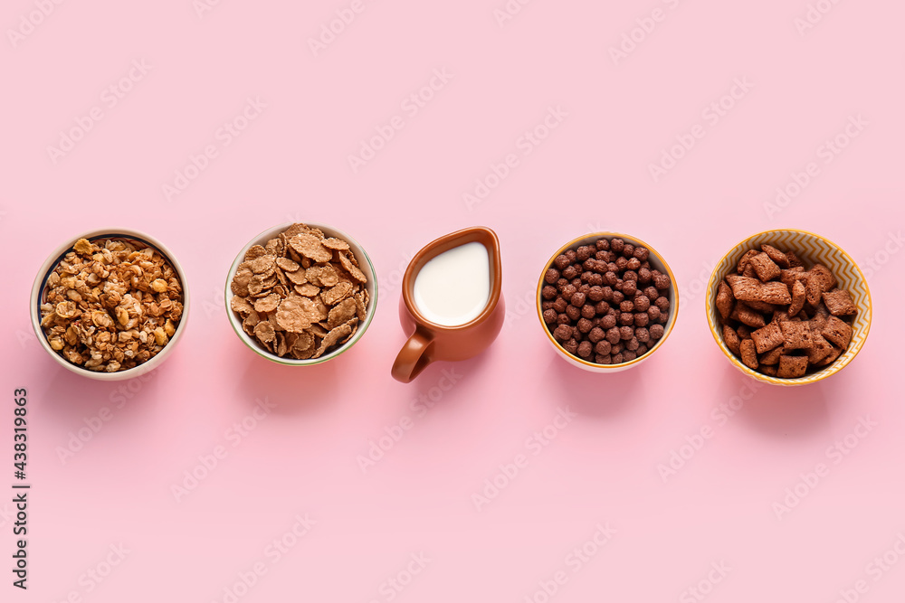 Bowls with different cereals and milk on color background Bowls with different cereals and milk on color background