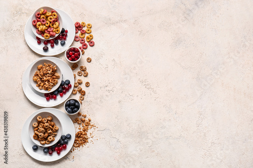 Composition with different cereals and berries on light background