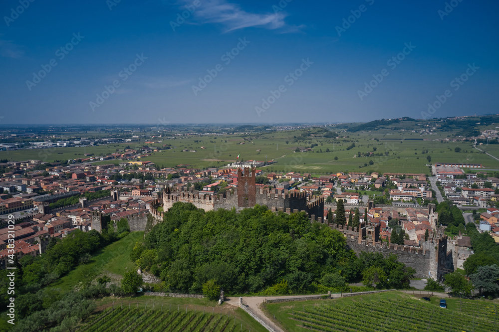 Aerial panorama of Italy castles. The delightful medieval town of Soave rises at the foot of the Lessinia Mountains. Soave castle aerial view, province of Verona, Italy.