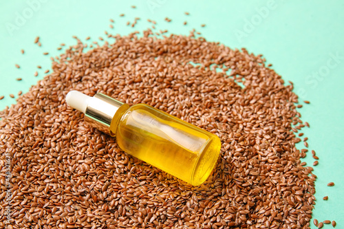 Composition with flax seeds and oil on color background, closeup