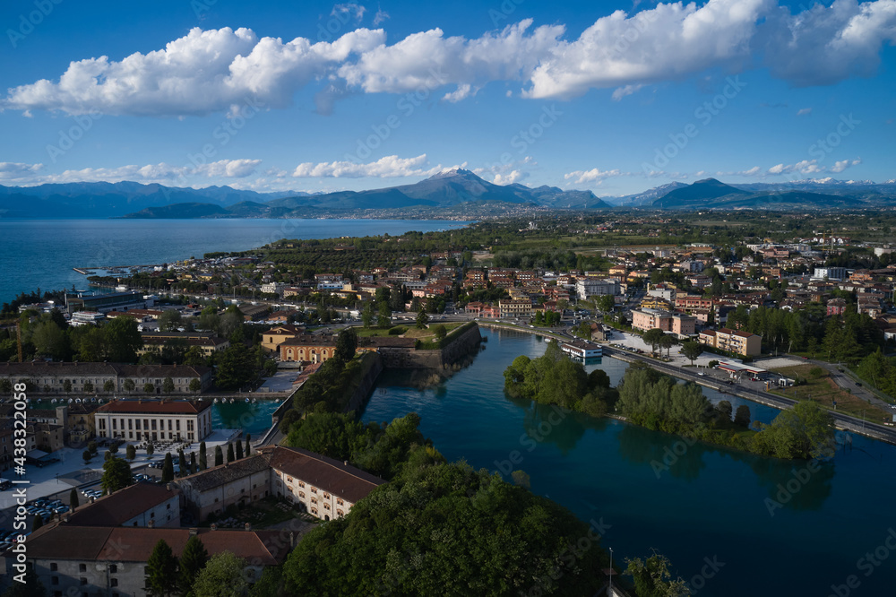 Aerial view of a tourist town in Italy. Italian resorts on Lake Garda. The city of peschiera del garda at sunset. Aerial panorama of the city of Peschiera del Garda on Lake Garda, Italy.