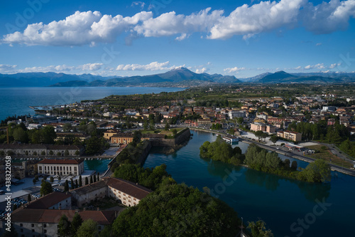 Aerial view of a tourist town in Italy. Italian resorts on Lake Garda. The city of peschiera del garda at sunset. Aerial panorama of the city of Peschiera del Garda on Lake Garda, Italy. © Berg