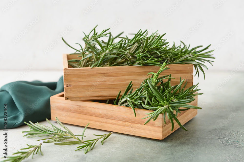 Boxes with fresh rosemary on color background Boxes with fresh rosemary on color background