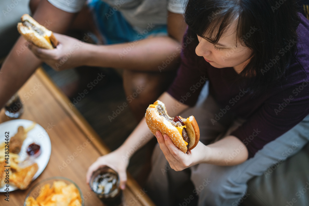 Couple having fast food on the couch Couple having fast food on the couch